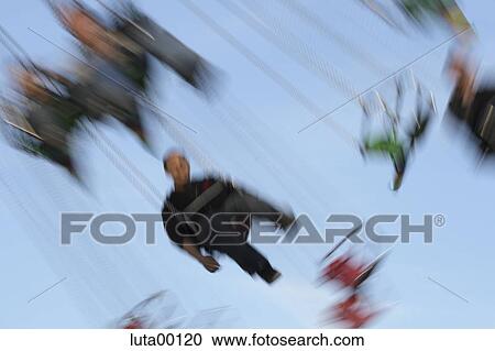 Stock Image - outdoor shot, outside, movement, move, spare time, fair, carousel. Fotosearch