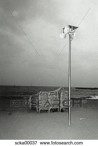 Stock Photo - put together, beach, sandy beach, beach lounger, deckchair, tidy, evening. Fotosearch