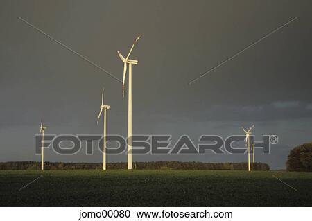 renewable energies, wind power stations, wind farm, windmills, wind energy, energy generation, thunderstorm View Large Photo Image Stock Image - renewable energies, wind power stations, wind farm, windmills, wind energy, energy generation, thunderstorm. Fotosearch