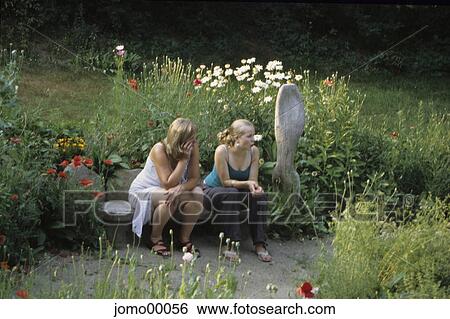 Stock Photograph - sitting, garden art, mother and daughter, pause, scantily clad, scantily dressed, peaceful. Fotosearch
