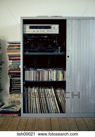 Stock Image - stereo, locker, roll-fronted cabinet, records, books, stack of books, interior. Fotosearch
