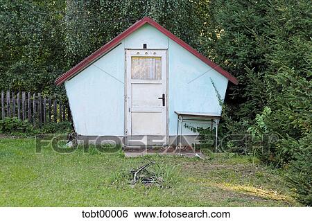 Stock Photograph - vacation home, camping table, in the green, brokerage, pointed roof, fireplace, campfire. Fotosearch