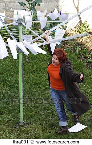 Stock Image - woman, author, strawberry blonde, leaves, blades, clothesline, scripture. Fotosearch