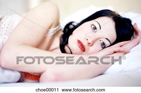 Stock Image - woman, brown eyes, ceiling, fair skin, young woman, pout, negligee. Fotosearch