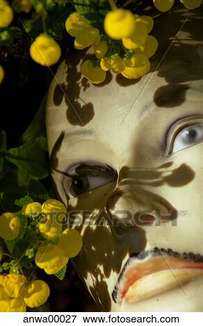 Stock Photo - yellow flowers, androgynous, dummy, doll, puppet, beard, flower bed. Fotosearch