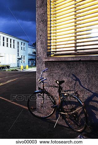 Stock Image - bicycle, night, blue, light, building, buildings, old. Fotosearch