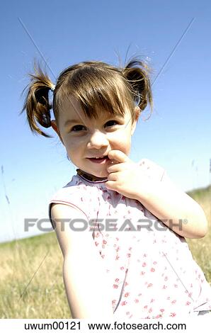 Stock Image - child, cute, baby, standing, outdoor shot, outside, suspicious. Fotosearch