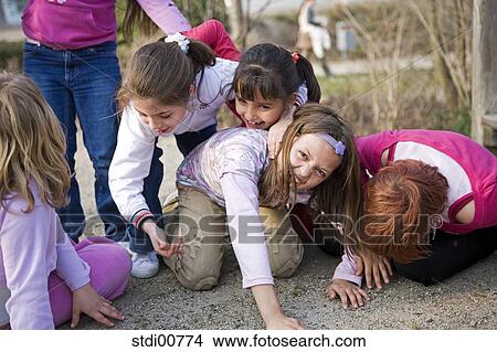 Picture - child, playing children, children, young, laugh, pools, trees. Fotosearch