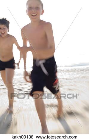 Stock Photo - fun, happy, high key, desire, beach, sun, luck. Fotosearch