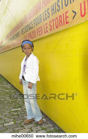 Stock Image - girl, model, stand, boards, cordon, barrier, building site. Fotosearch