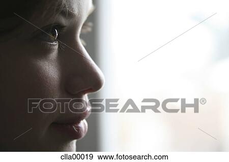 Stock Photo - half face, woman, big eyes, pout, full lips, womanlike, female. Fotosearch
