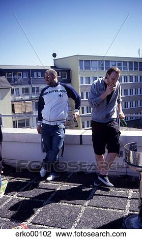 Stock Image - men, standing, summer, party, shadow, summers. Fotosearch