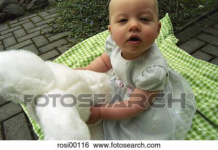 Stock Photograph - small, baby, girl, infant, attentive, curious, Easter. Fotosearch