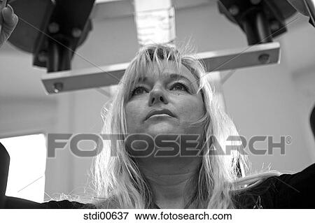 Stock Photo - strength training, build-up of muscles, sport, studio, woman, bodybuilding, fitness. Fotosearch