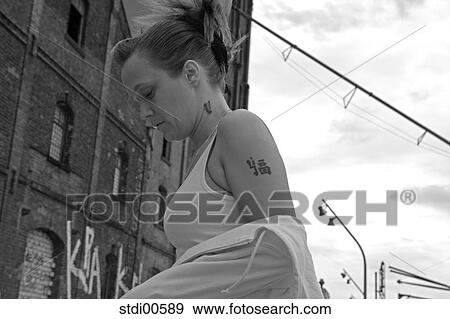 Stock Photo - tattoo, bodybuilding, sport, strength training, woman, vamp, arms. Fotosearch