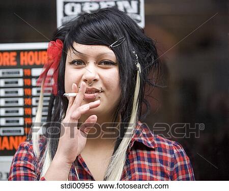 woman, barrette, lip piercing, nose piercing, black hair, tattoo, smoke View Large Photo Image Stock Photography - woman, barrette, lip piercing, nose piercing, black hair, tattoo, smoke. Fotosearch