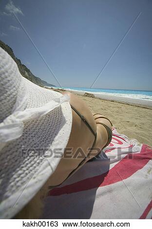 Stock Image - woman, beach, hat, bikini, rest, holiday, leave. Fotosearch