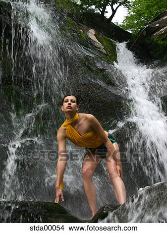 Picture - woman, brunette, full body, years old, model, downwards, close to nature. Fotosearch