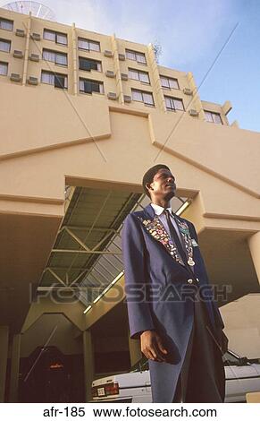 Stock Photography - Doorman Outside Hotel Harare Zimbabwe. Fotosearch