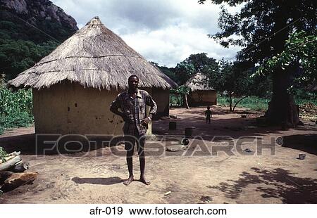 Man Standing outside a Mud Hut Zimbabwe Africa View Large Photo Image Stock Photo - Man Standing outside a Mud Hut Zimbabwe Africa. Fotosearch