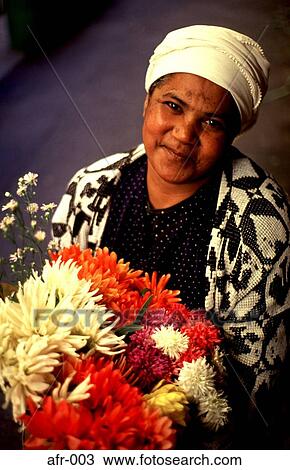 Smiling Woman Holding a Bunch of Flowers Africa View Large Photo Image Stock Image - Smiling Woman Holding a Bunch of Flowers Africa. Fotosearch