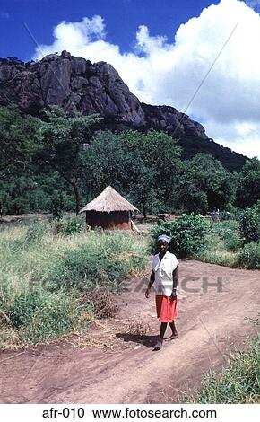 Stock Image - Woman Walking in Village Zimbabwe Africa. Fotosearch