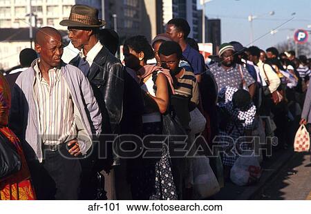 Stock Image - Workers in Bus Queue Johannesburg South Africa. Fotosearch