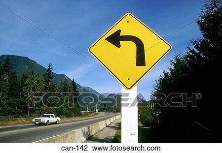 Stock Image - Sign Warning of Left Turn Canada. Fotosearch
