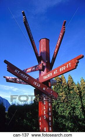 Stock Photo - Wooden Signpost to Mountain Peaks Hope Canada. Fotosearch