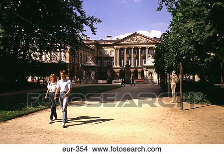 Picture - Couple Walking from Palace de la Nation Brussels. Fotosearch