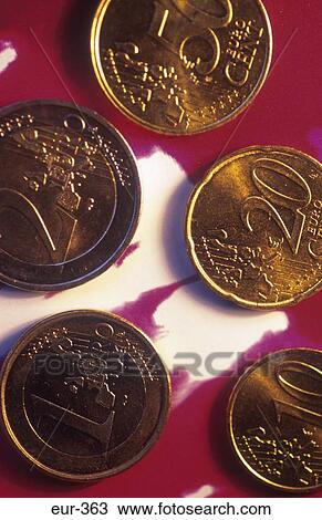 Stock Image - Display of Euro Coins on Red Background. Fotosearch