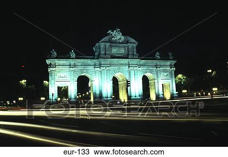 Stock Image - Floodlit Puerta De Alcala Plaza De La Independencia. Fotosearch