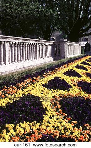 Stock Image - Formal Flower Bed Beside Column Stone Wall Geneva. Fotosearch