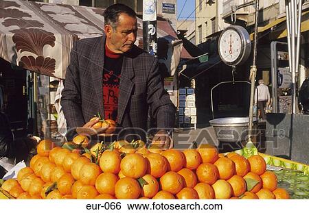 Stock Photograph - Oranger Man Market Trader Athens Greece. Fotosearch