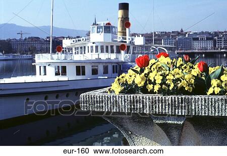 Stock Image - Paddle Steamer Moored Beside Flower Bed Geneva. Fotosearch