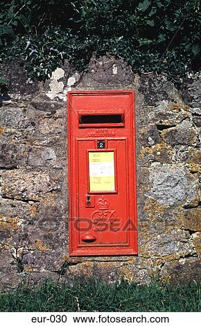 Stock Image - Red Letterbox in a Wall UK. Fotosearch