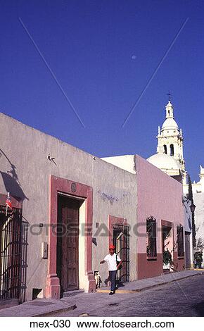 Stock Image - Man Walking by Colonial Houses Monterrey Mexico. Fotosearch