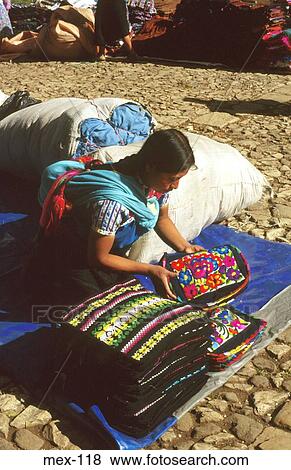 Stock Photo - Woman Selling Traditional Textiles at Market Mexico. Fotosearch