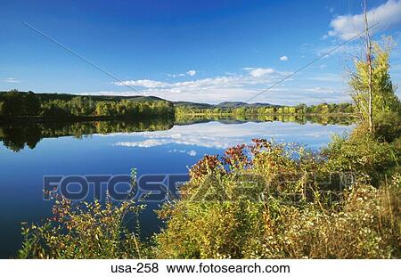 Banks and Sky Reflected in Lake New Hampshire USA View Large Photo Image Stock Photo - Banks and Sky Reflected in Lake New Hampshire USA. Fotosearch