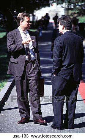 Stock Image - Business Men Standing and Talking Boston USA. Fotosearch