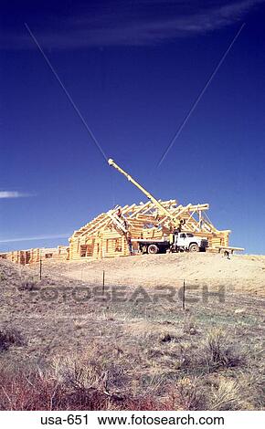Stock Image - Constructing Log Cabin Colorado. Fotosearch