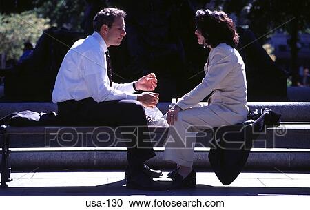 Stock Image - Couple Sitting Facing Together Boston USA. Fotosearch