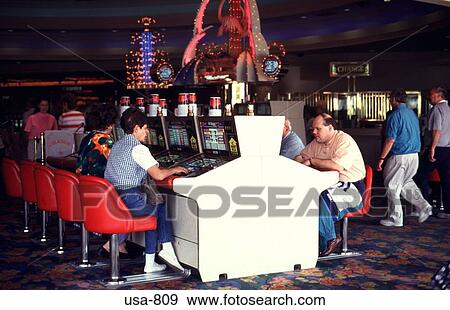 Gamblers at Machines in Las Vegas Casino View Large Photo Image Stock Photo - Gamblers at Machines in Las Vegas Casino. Fotosearch