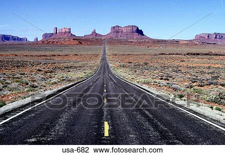 Stock Image - Highway into the Distance Monument Valley Arizona. Fotosearch