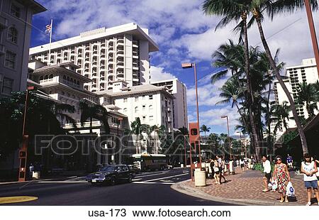 Stock Image - Hotel and Palm Lined Street Waikiki Hawaii USA. Fotosearch