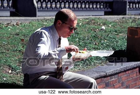 Stock Image - Office Worker Eating Lunch Boston USA. Fotosearch