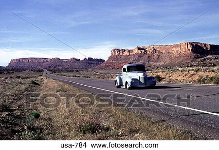 Picture - Old Car Driving along Highway Utah. Fotosearch