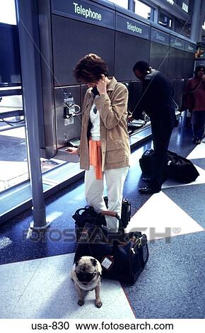 Stock Image - People Using Telephones O'Hare Airport Chicago. Fotosearch