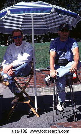 Stock Image - Traders Sitting Under a Canopy Boston USA. Fotosearch