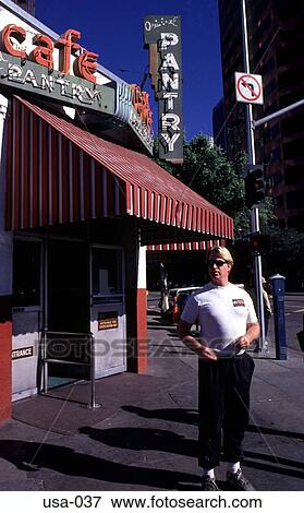 Stock Photo - Young Man outside a Corner Cafe Los Angeles. Fotosearch